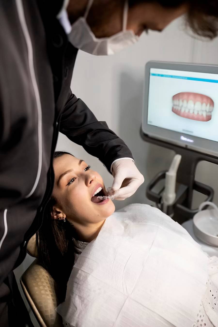 Dentist examining a patient's teeth with a dental scanner